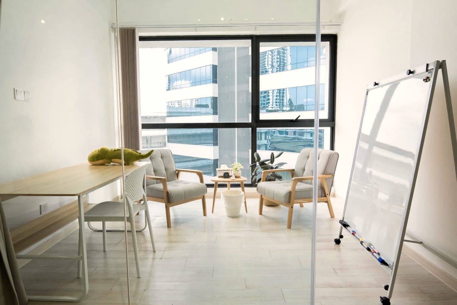 A therapy room at Safe Space with two armchairs by the window